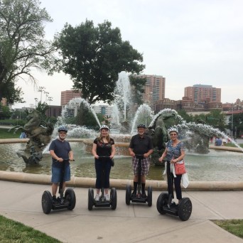 family in front of fountain